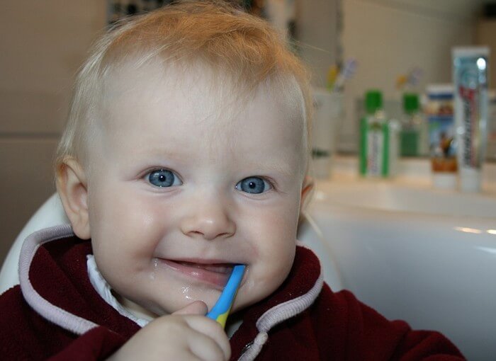 When should I begin brushing my baby’s teeth